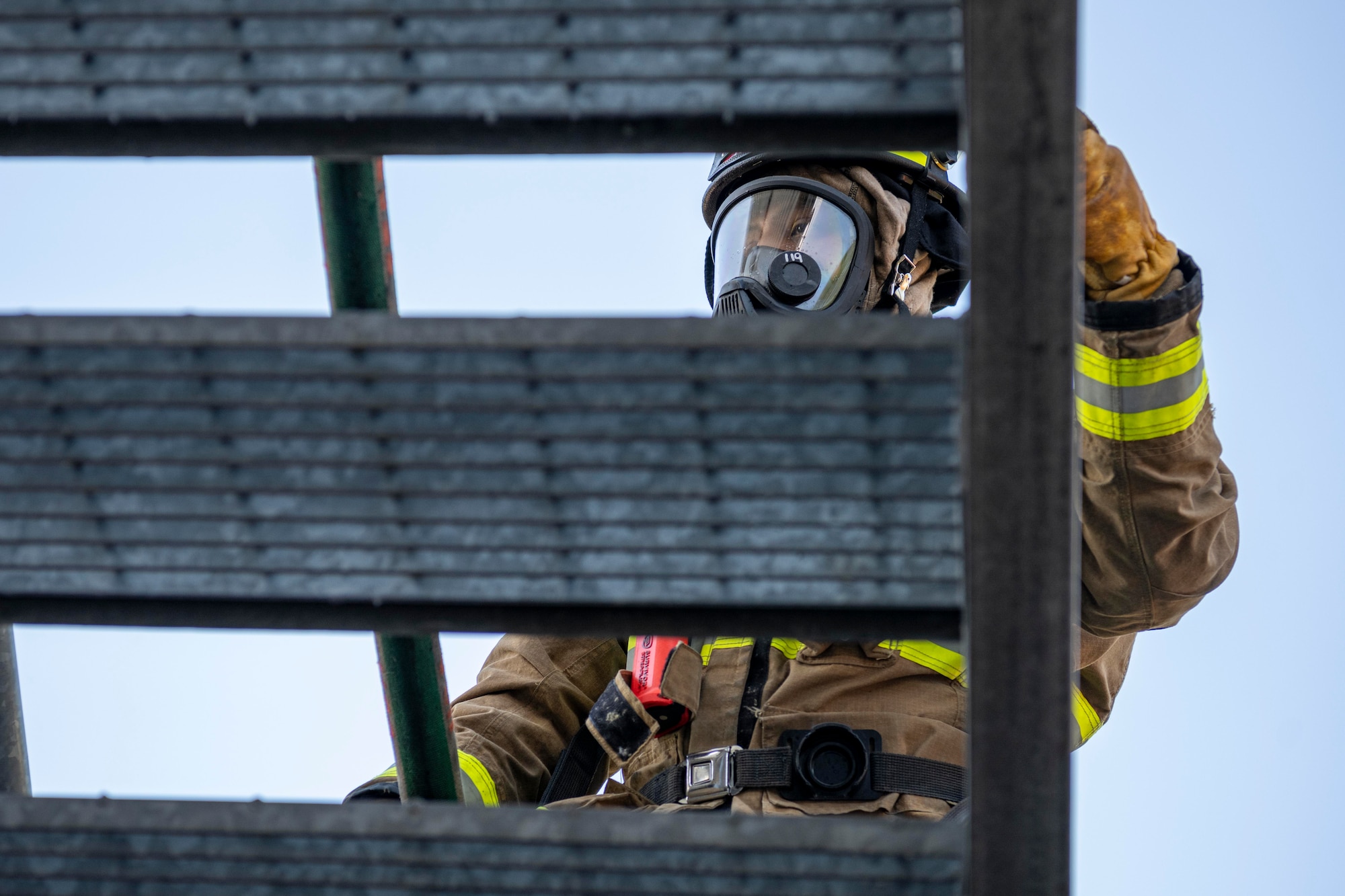 A firefighter walking up stairs.