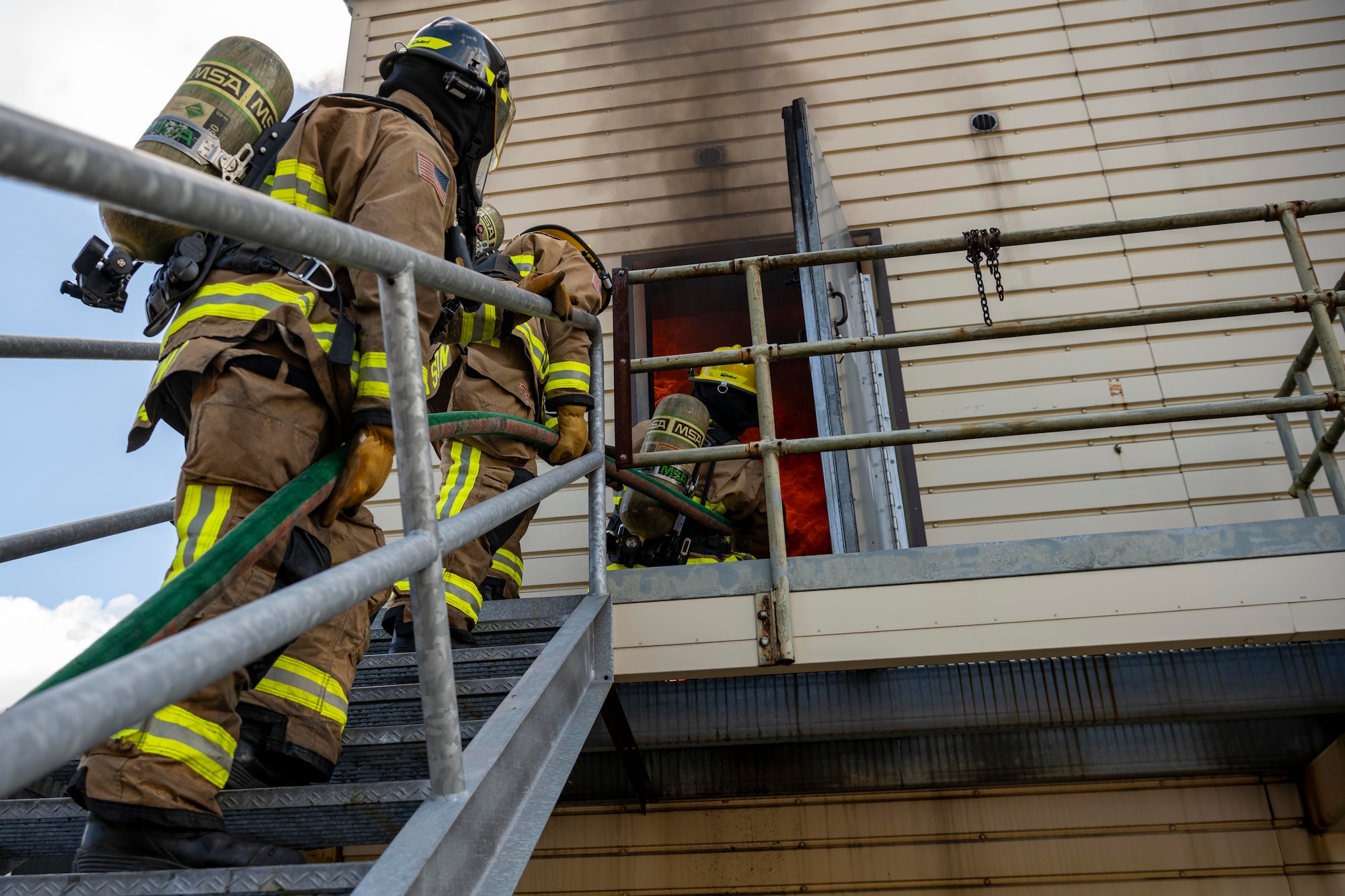 Firefighters walking up stairs.