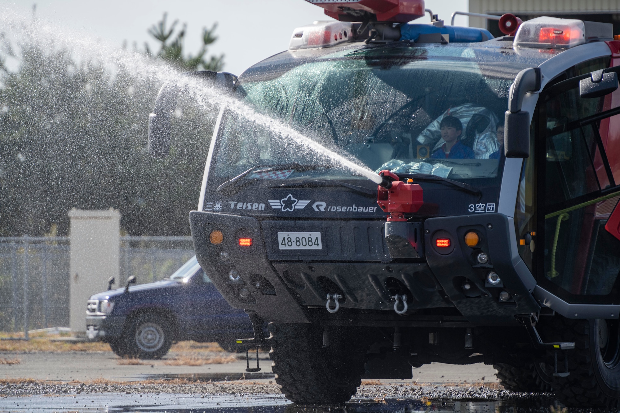 A fire truck spraying water.