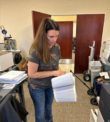 woman fanning documents
