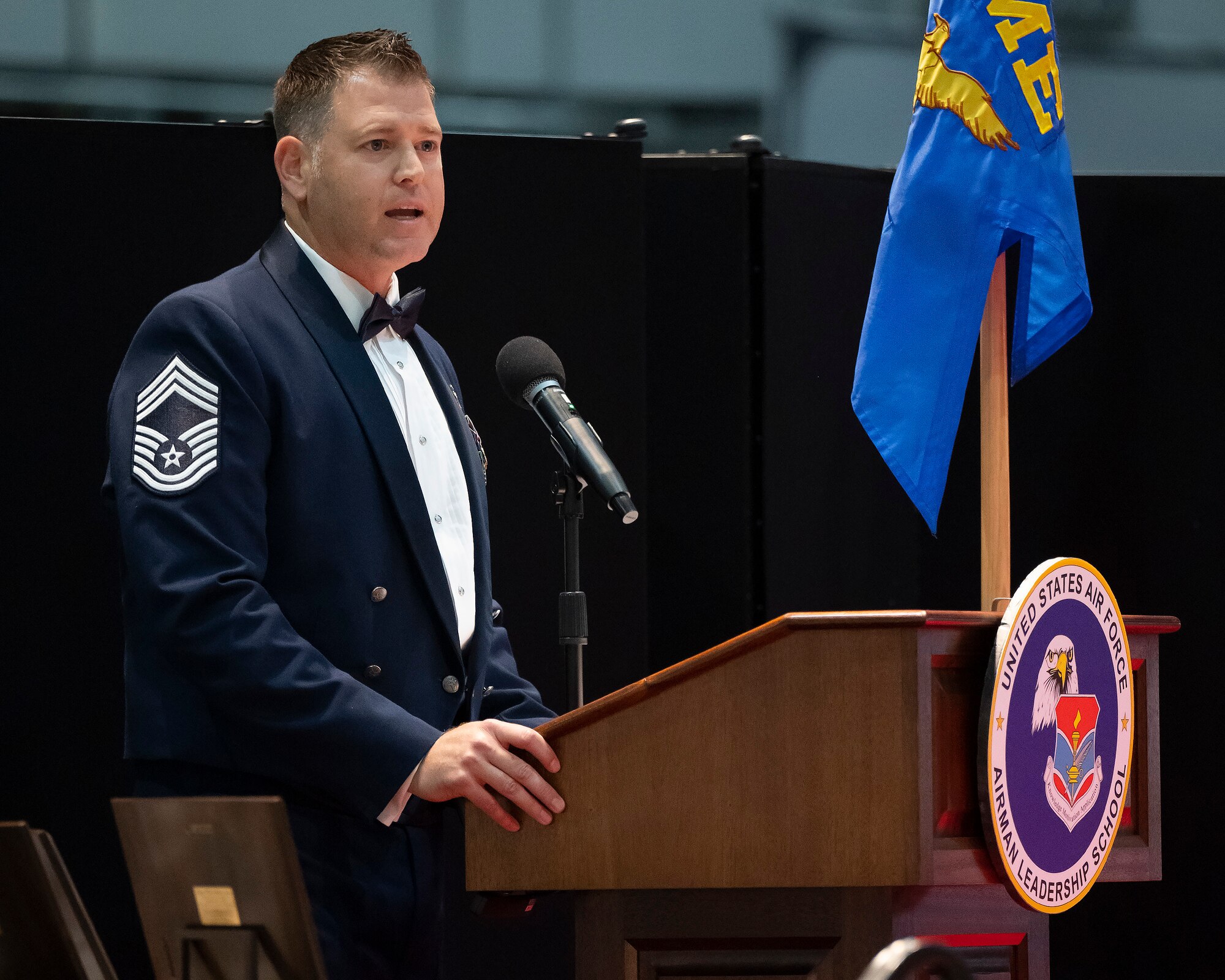 A man in an Air Force uniform with a lot of stripes speaks at a podium.