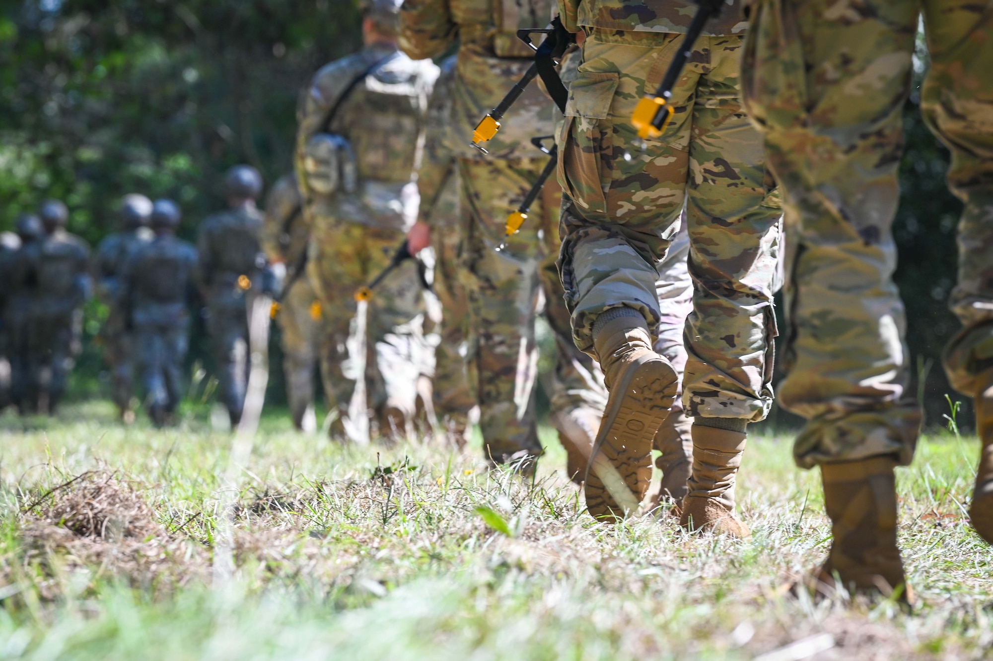 Airmen and Soldiers march in a line.