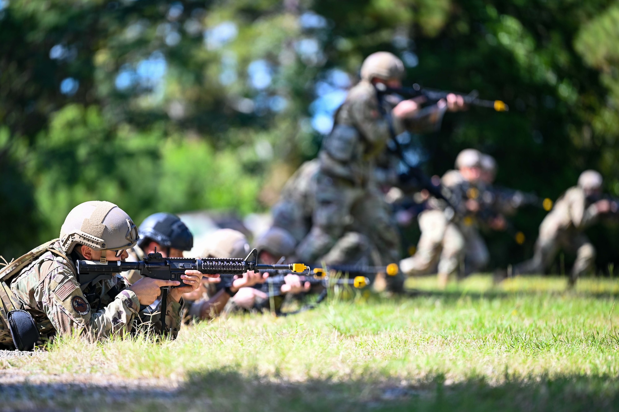 Airmen holding rifles are in formation.