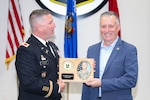 Col. Paul Gapinski, outgoing commander of the Wisconsin Army National Guard’s 426th Regiment, presents retired Col. Andrew Ratzlaff with a plaque signifying his induction into the 426th Regional Training Institute (RTI) Hall of Fame during an induction ceremony Oct. 14 at Fort McCoy, Wis.
