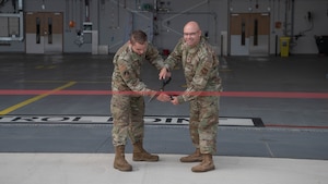 commander and airmen cut a ribbon opening the facility