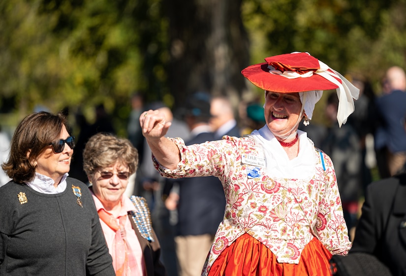 a reenactor waves during a parade