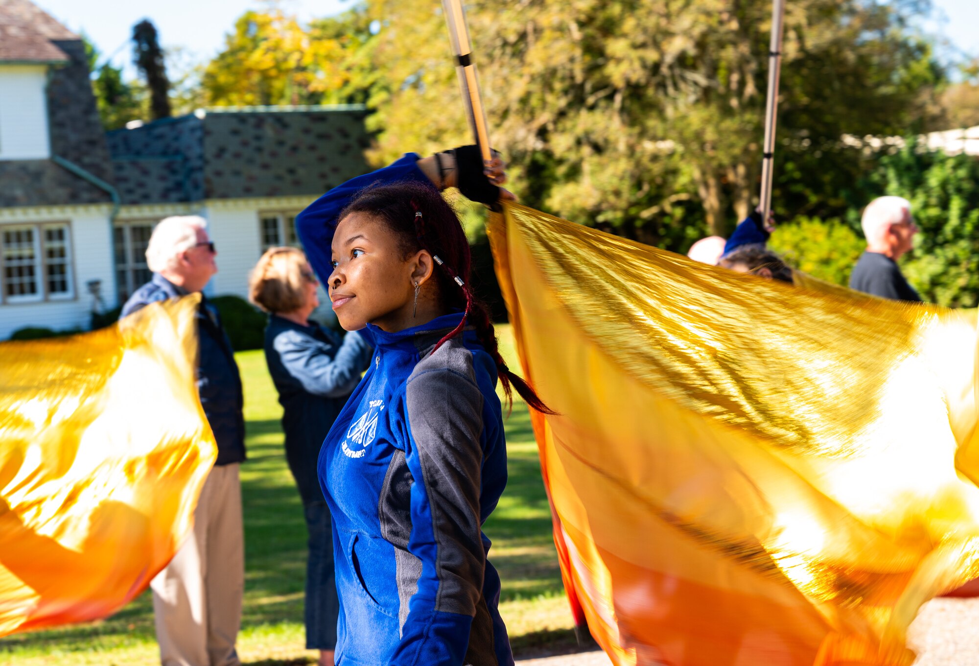 A young girl performs with a flag