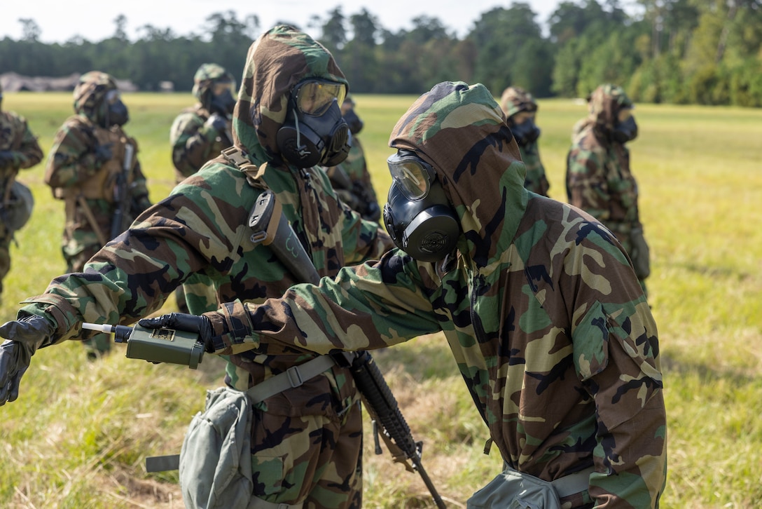 U.S. Marines with II Marine Expeditionary Force Support Battalion check their protective equipment for Chlorobenzyl Dene Malononitrile, more commonly known as CS gas, during Gladius Forge 23.2 at LZ Egret, Camp Lejeune, North Carolina, Sep. 26, 2023. Gladius Forge 23.2 is a II MSB field exercise in conjunction with 8th Communication Battalion, 2d Supply Battalion, and 2d Medical Battalion to execute mission essential tasks, while validating the battalion’s support capabilities and proficiency. (U.S. Marine Corps photo by Lance Cpl. Christian Alston)