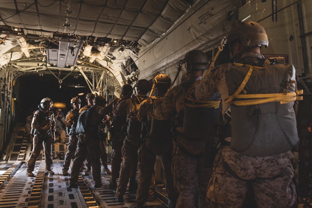 U.S. Marines attached to 8th Engineer Support Battalion, Combat Logistics Regiment 27, 2nd Marine Logistics Group, perform pre-jump safety procedure for air delivery operations during Weapons and Tactics Instructor course 1-24 in Yuma, Arizona, Oct. 10, 2023. WTI 1-24 is an advanced seven-week course, which provides standardized tactical training and incorporates Marine Corps planning and implementation of air and ground tactics through a series of escalating evolutions, to support Marine aviation training and readiness. (U.S. Marine Corps photo by Cpl. Meshaq Hylton)