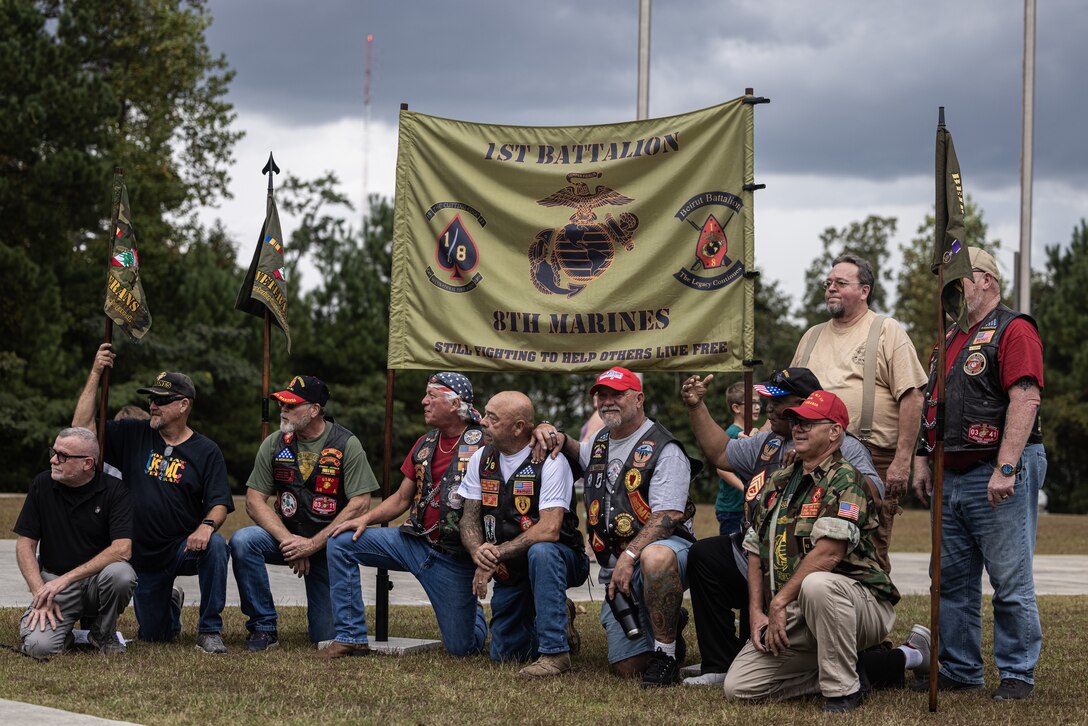 Veterans from Battalion Landing Team 1/8  pose for a photo during the opening ceremony for the Beirut Memorial Run at the Lejeune Memorial Gardens in Jacksonville, North Carolina, Oct. 20, 2023. The Beirut Memorial Run is an annual event that honors the Marines that died in the bombing of the Marine Barracks in Beirut, Lebanon on Oct. 23, 1983. Participants run a total of 241 laps for each service member that died in the bombing. (U.S. Marine Corps photo by Lance Cpl. Ryan Ramsammy)