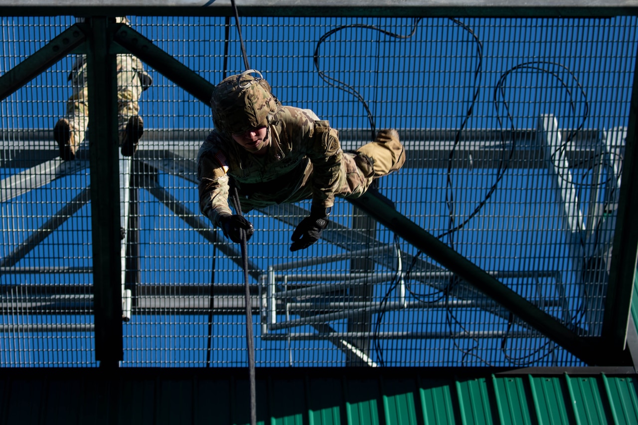 A soldier rappels during training.