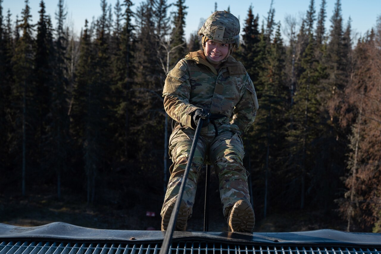 A uniformed service member participates in rappel training.