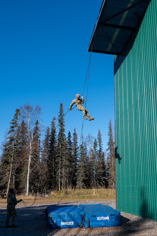 A uniformed service member participates in rappel training.