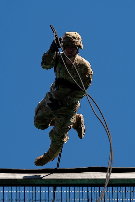 A uniformed service member participates in rappel training.