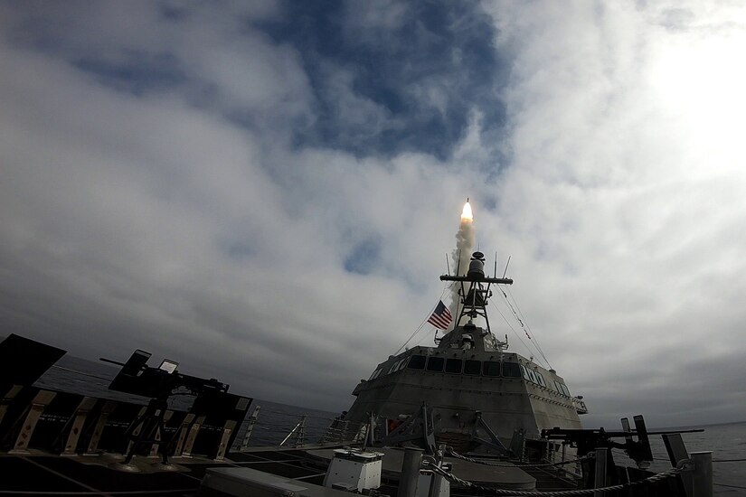 A missile is launched from a ship at sea.
