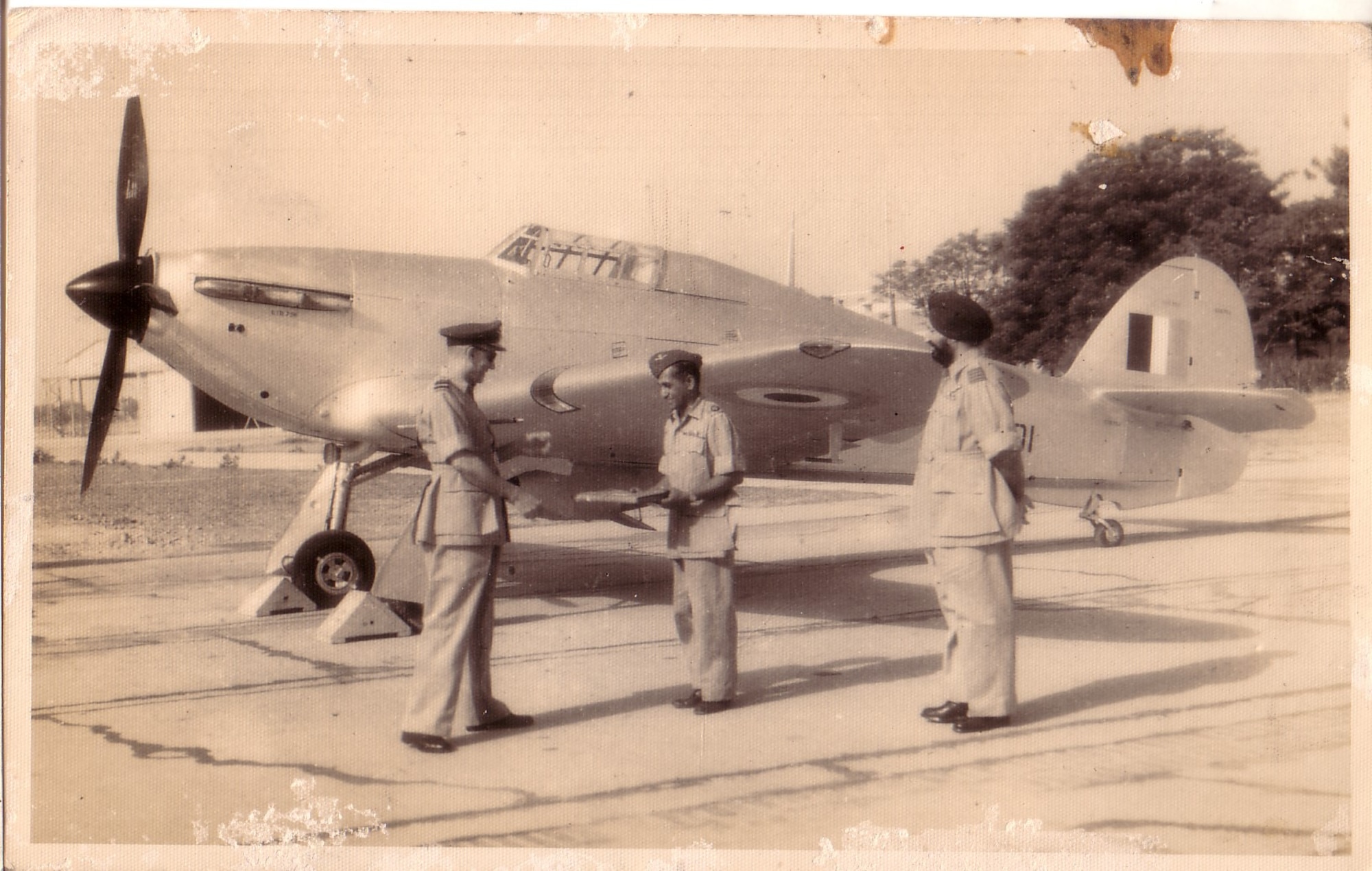 Swami Iyer’s grandfather receives recognition from leadership in front of a Hawker Hurricane aircraft. (Courtesy photo