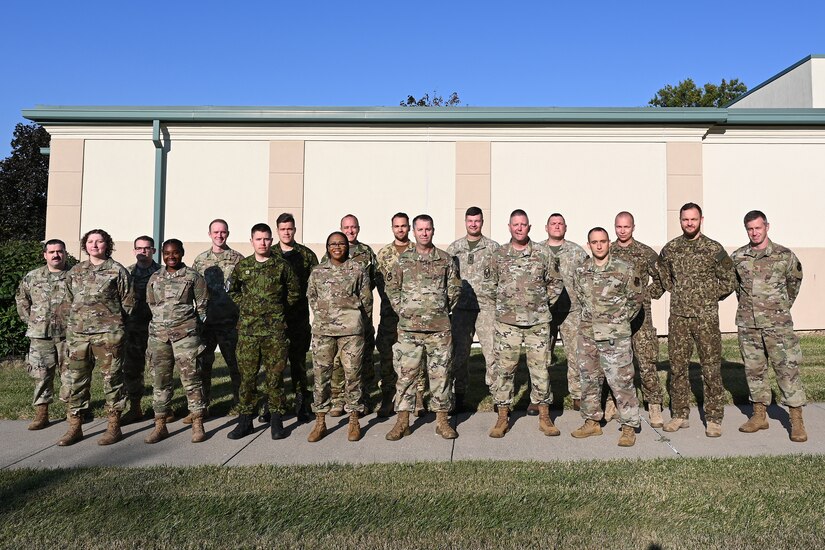 Service members pose for a picture.