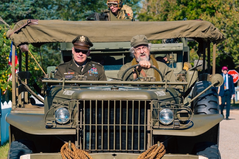 U.S. Army Maj. Gen. John D. Kline, Center for Initial Military Training commanding general, rides with a reenactor during the Yorktown Day Parade, Oct. 19, 2023. The observance of Yorktown Day traces its roots to 1922, starting a yearly tradition that now includes a parade and reenactors. (U.S. Air Force photo by Airman 1st Class Ian Sullens)