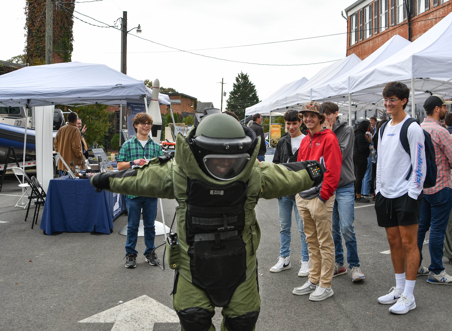 IMAGE: Rappahannock High School senior Andrew Maldonado dances while wearing an explosive ordnance disposal bomb suit at the Dahlgren Downtown Forging Community Partnerships event hosted by Naval Surface Warfare Center Dahlgren Division Oct. 20 at The Silk Mill in Fredericksburg.