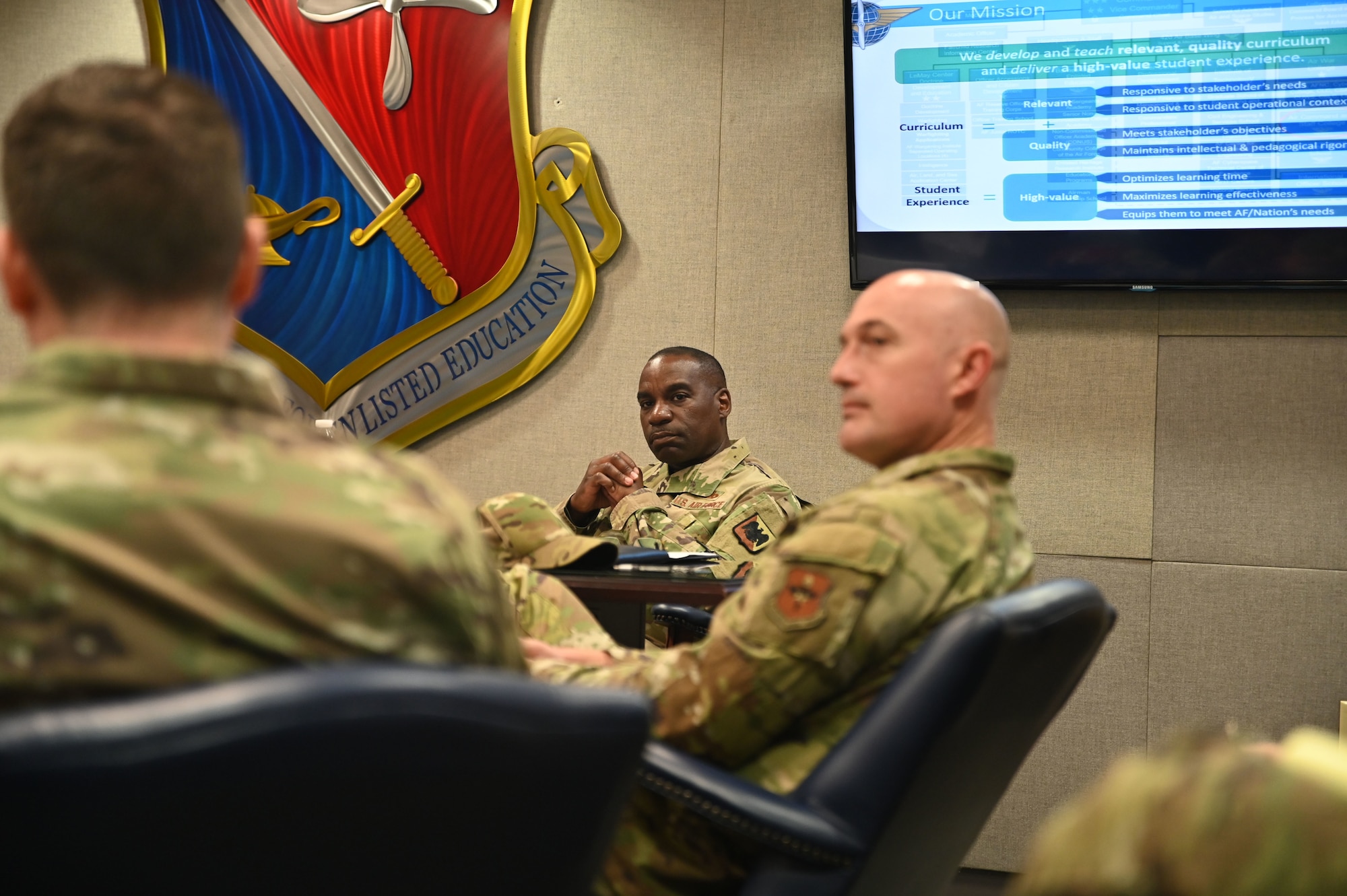 U.S. Air Force Chief Master Sgt. Maurice L. Williams, center, command chief, Air National Guard, listens as he is briefed on the current curriculum and student experience offered during a visit to the Thomas N. Barnes Center, Maxwell-Gunter Annex, Alabama, Oct. 18, 2023. Williams wanted to better understand where course improvements are most needed to enhance the overall distance learning experience for all Airmen. (U.S Air National Guard photo by Master Sgt. Chelcee Arnold)