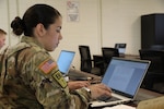 U.S. Army Spc. Mary Ruiz, an aviation operations specialist representing the Marietta-based 78th Aviation Troop Command, Georgia Army National Guard, writes an essay at the 2023 Georgia National Guard State Best Warrior Competition held March 5-10, 2023, at Fort Stewart, Georgia. The competition recognized Georgia's best Soldiers and tested readiness of the Georgia Army National Guard. (U.S. Army National Guard photo by Pvt. Ayanna Tillman)