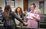 BIPOC Employee Resource Group co-leads Ashley Jackson, left, and Taylor Lindbom, middle, visit with Anti-Harassment and Discrimination Team co-lead Merritt Boggess Oct. 11, 2023, after receiving Special Achievement Awards in the Puget Sound Naval Shipyard & Intermediate Maintenance Facility Auditorium, in Bremerton, Washington. (U.S. Navy photo by Wendy Hallmark)