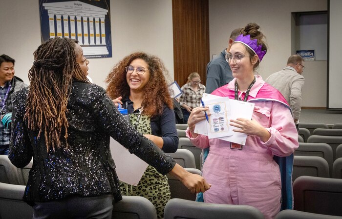 BIPOC Employee Resource Group co-leads Ashley Jackson, left, and Taylor Lindbom, middle, visit with Anti-Harassment and Discrimination Team co-lead Merritt Boggess Oct. 11, 2023, after receiving Special Achievement Awards in the Puget Sound Naval Shipyard & Intermediate Maintenance Facility Auditorium, in Bremerton, Washington. (U.S. Navy photo by Wendy Hallmark)