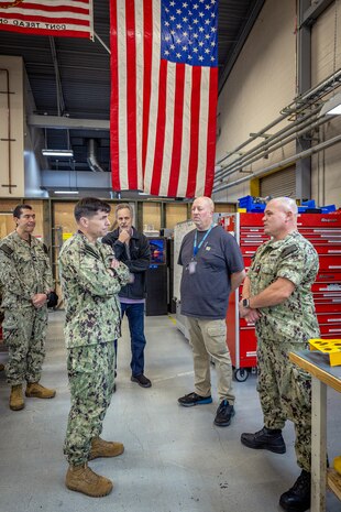 Capt. JD Crinklaw, commander, Puget Sound Naval Shipyard & Intermediate Maintenance Facility, visits with Sailors and employees as he tours the Close-in Weapons Systems repair shop Oct. 16, 2023, during a tour of PSNS & IMF Detachment Everett, Washington. Crinklaw also toured the tool room, Electronics shop and the Shop 31D Pump/Valve repair shop during his visit. (U.S. Navy photo by Scott Hansen)