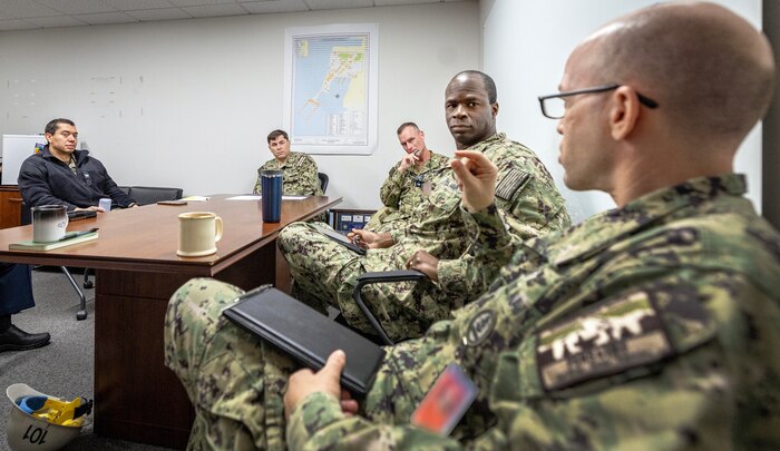 Capt. JD Crinklaw, commander, Puget Sound Naval Shipyard & Intermediate Maintenance Facility, meets with Capt. Ash Wright, deputy commander, Northwest Regional Maintenance Center, Cmdr. Brandon Johnson, executive officer, Code 100A, Cmdr. Jermaine Bailey, officer in charge, PSNS & IMF Detachment Everett, and Command Senior Chief Joel Hagstrom, Northwest Regional Maintenance Center, Oct. 16, 2023, during a tour of PSNS & IMF Detachment Everett, Washington. (U.S. Navy photo by Scott Hansen)