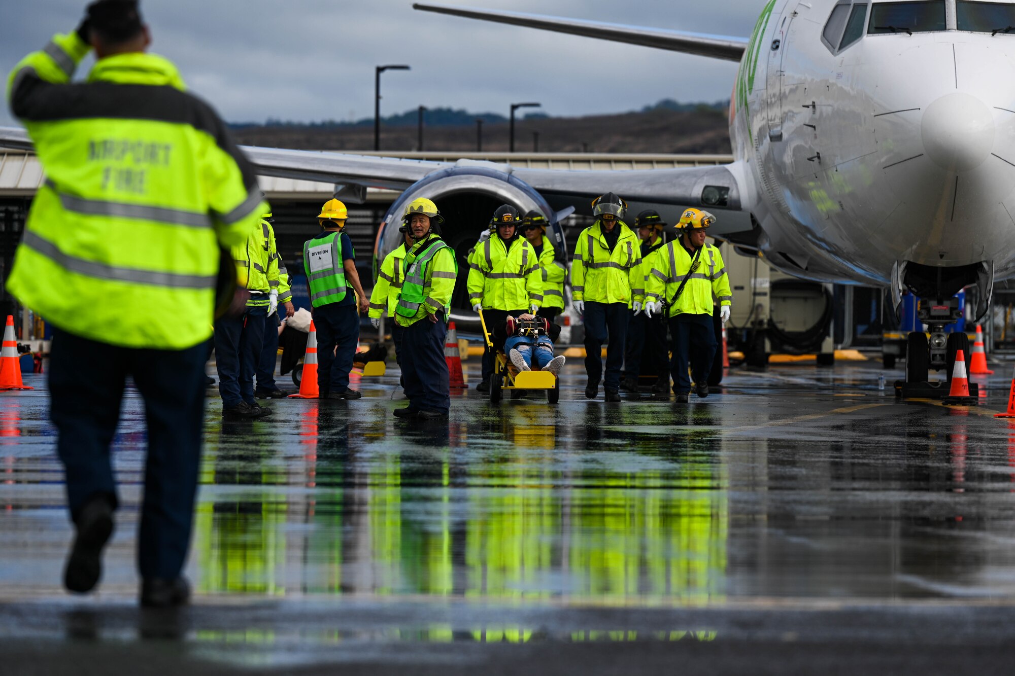 First responders attend to simulated patients during the triennial airport disaster exercise at Daniel K. Inouye International Airport, Oct. 20, 2023. This simulated full-scale aircraft emergency disaster exercise is a mandatory certification requirement by the Federal Aviation Administration that tests airfield disaster response and preparedness. (U.S. Air Force photo by Senior Airman Makensie Cooper)