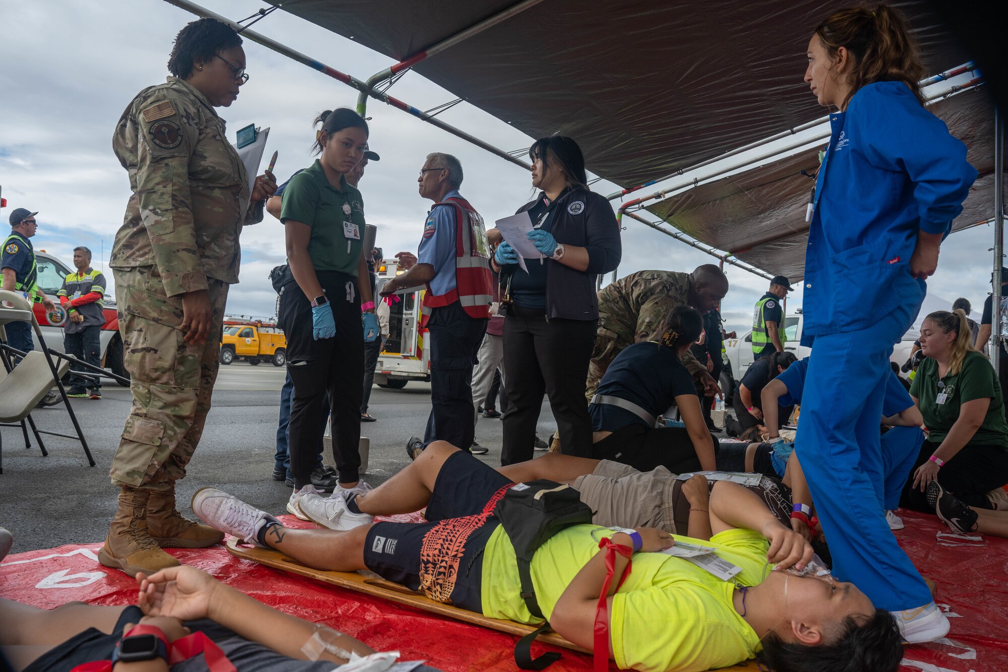 Capt. Folake Niniola, 15th Healthcare Operations Squadron Primary Care flight commander, coaches nursing students from across the island during a simulated triage as part of the triennial airport disaster exercise at Daniel K. Inouye International Airport, Oct. 20, 2023. Hickam Airmen observed nursing students from universities across the island who acted as medical response and injured patients during this multi-agency exercise. (U.S. Air Force photo by Senior Airman Makensie Cooper)