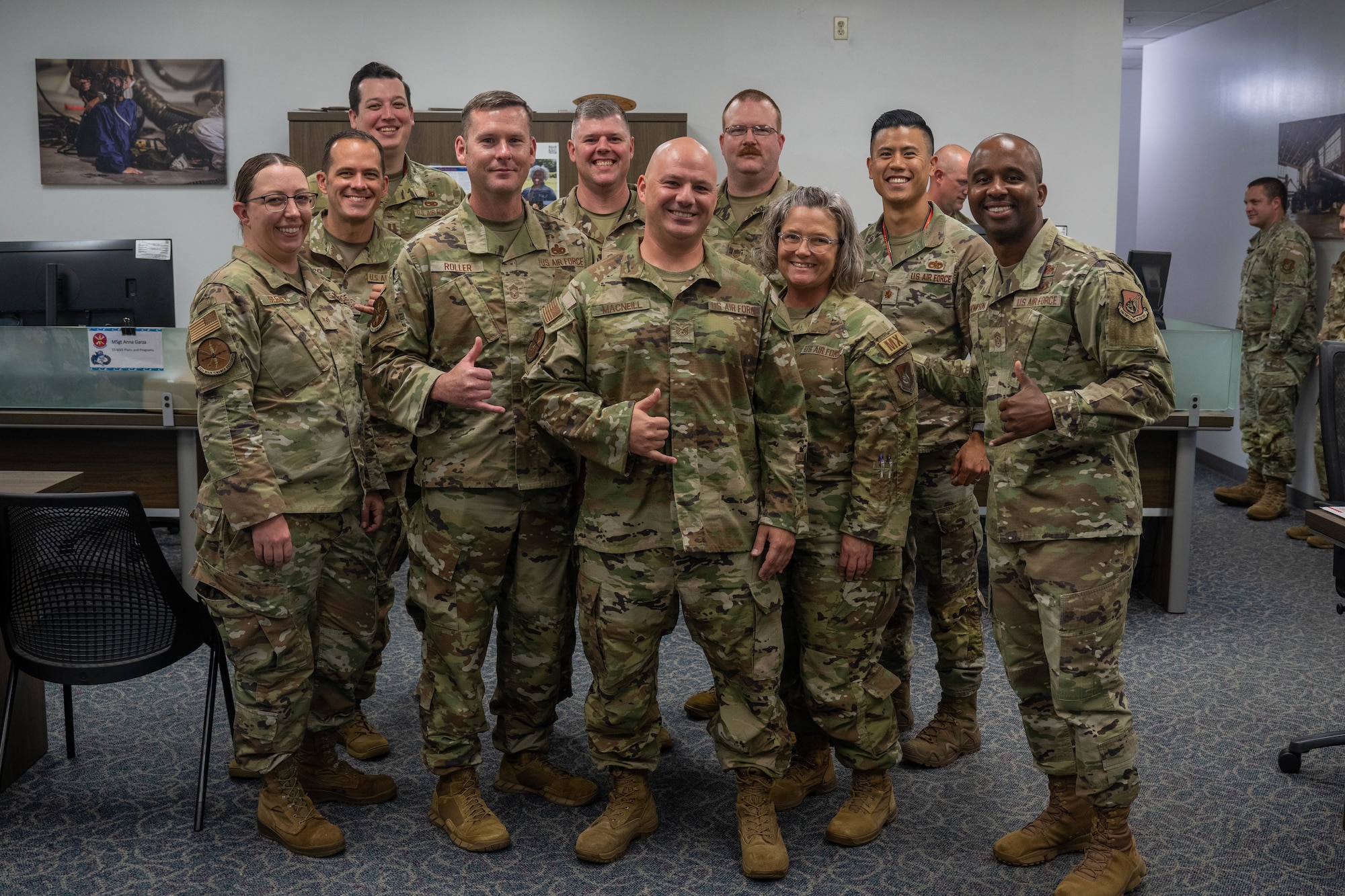 Tech Sgt. Robert MacNeill, 15th Maintenance Squadron commander support staff resource advisor, poses for a group photo with leadership and Airmen assigned to the 15th Maintenance Squadron at Joint Base Pearl Harbor-Hickam, Hawaii, Oct. 25, 2023. MacNeill was recognized as October’s Sky Warrior of the Month for advising leadership and flight chiefs, and successfully funding the Wing’s annual sorties. (U.S. Air Force photo by Senior Airman Makensie Cooper)