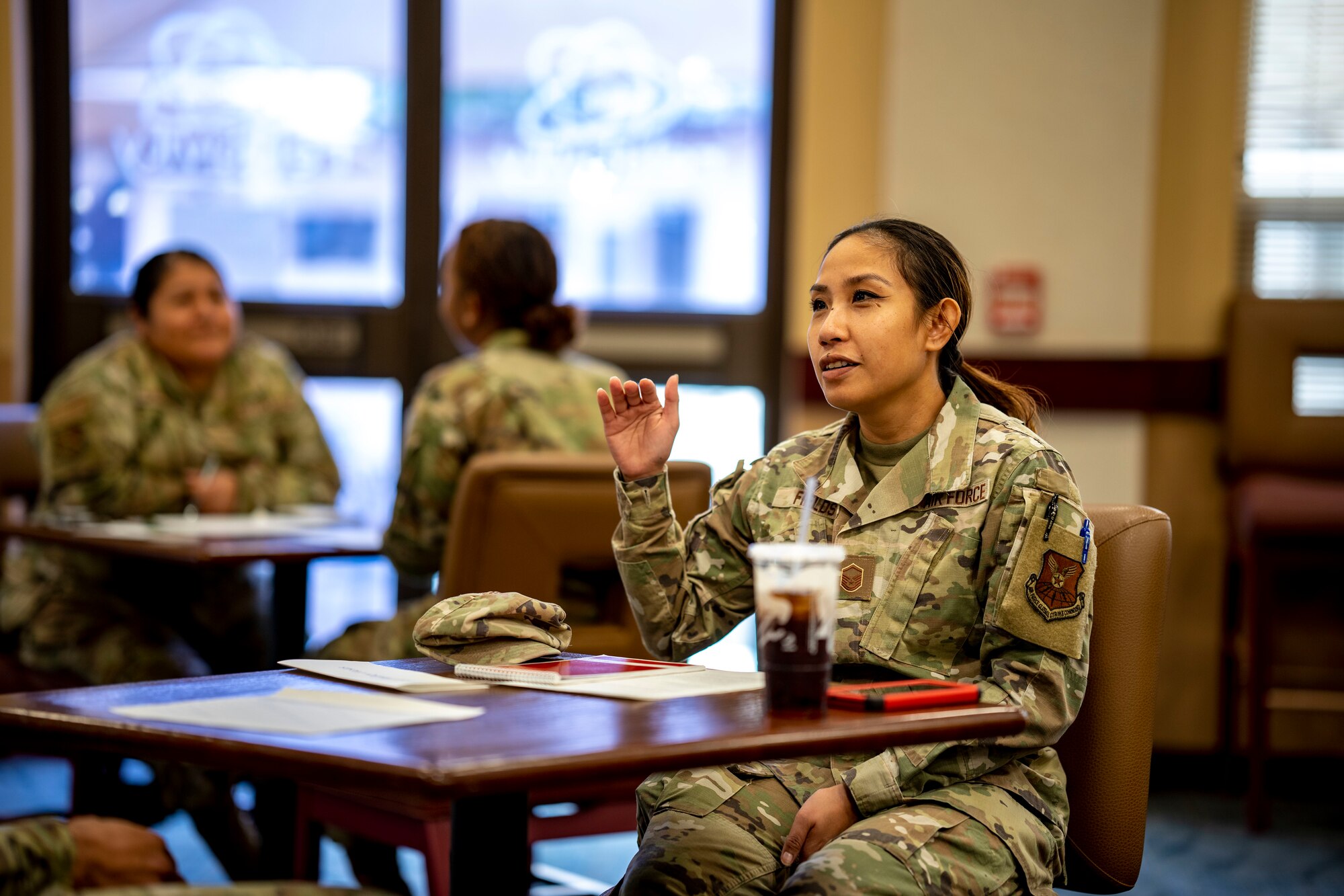 woman sits at table