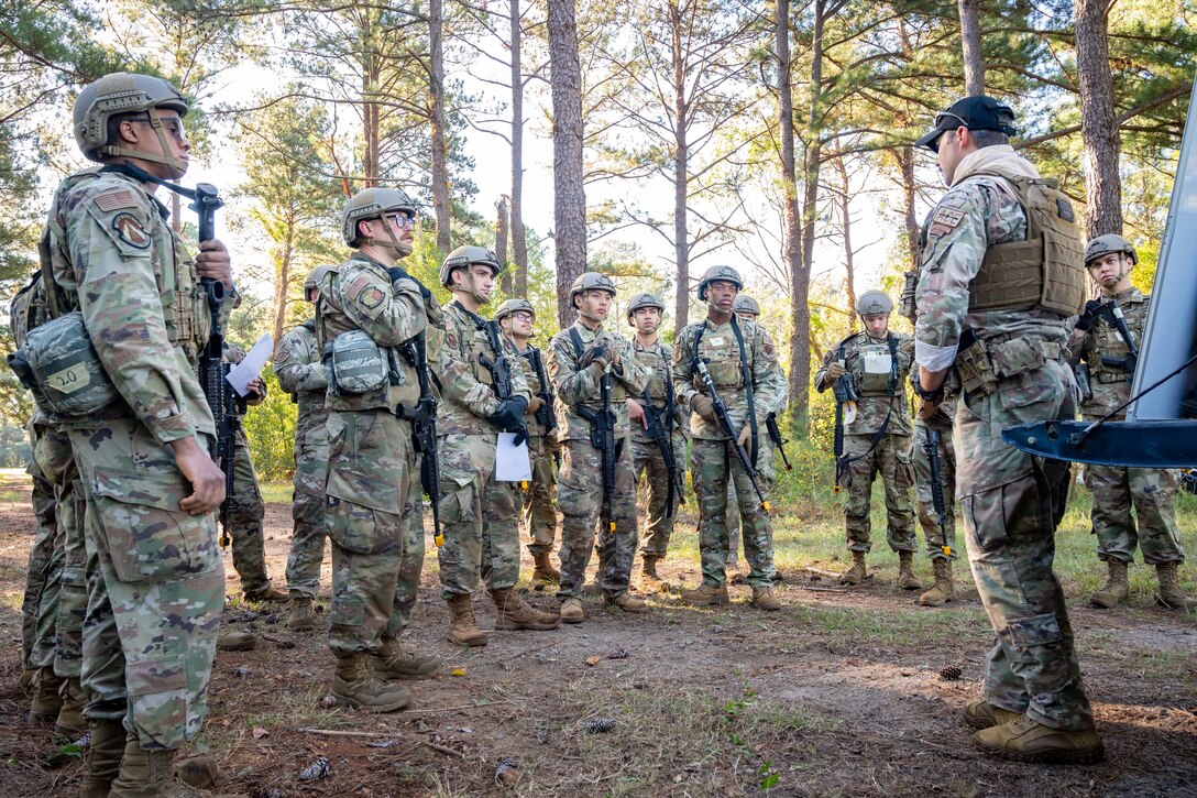 Airmen in a group receive instruction from an MCA intructor.