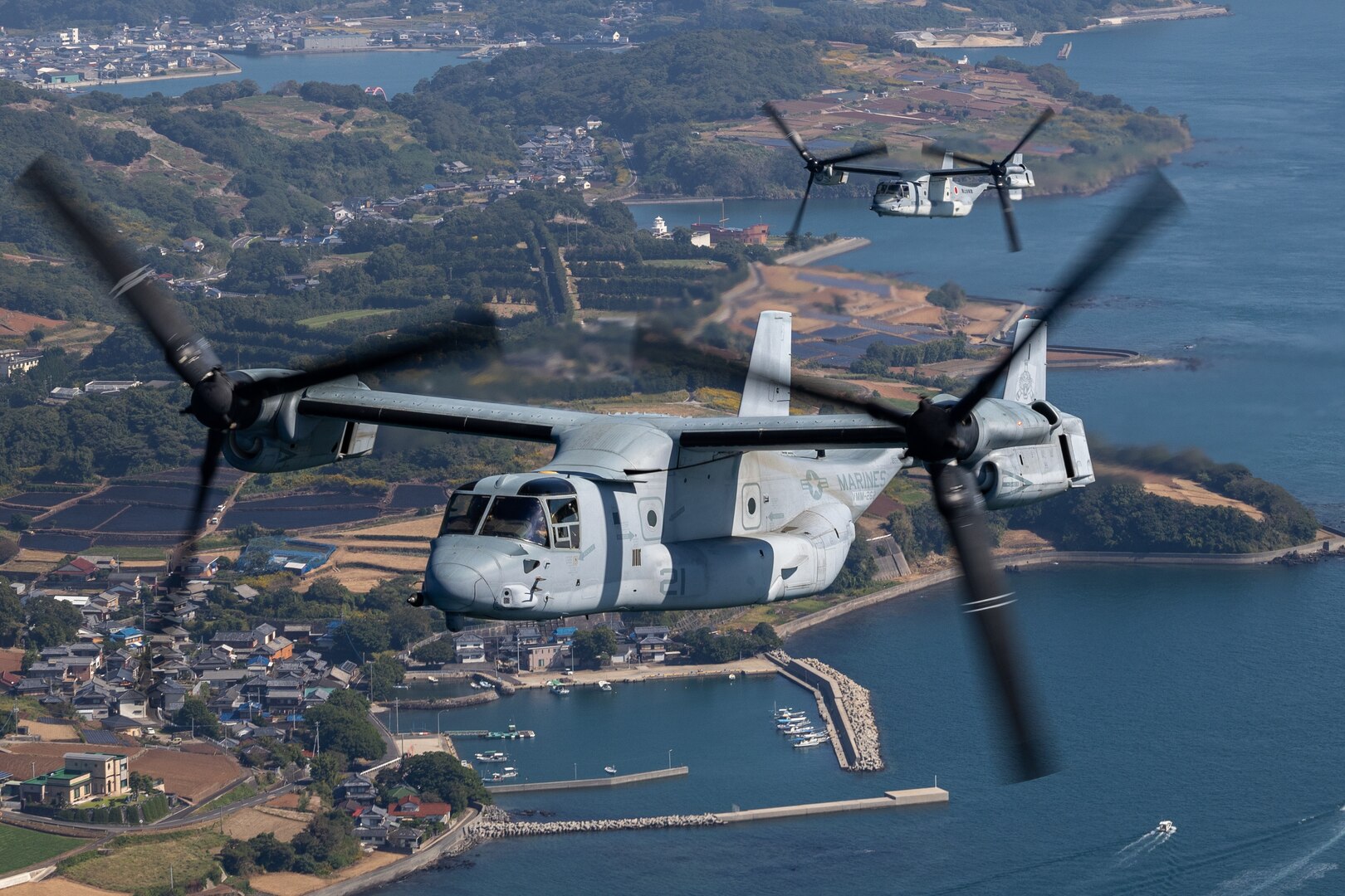 A U.S. Marine Corps MV-22 Osprey tiltrotor aircraft with Marine Medium Tiltrotor Squadron (VMM) 262, Marine Aircraft Group 36, 1st Marine Aircraft Wing, conducts a bilateral formation flight alongside a Japan Ground Self-Defense Force V-22 Osprey tiltrotor aircraft with 107th Squadron, Transport Aviation Group, 1st Helicopter Brigade, during the field training exercise portion of Resolute Dragon 23 off the coast of Kumamoto, Japan, Oct. 18, 2023. RD 23 is an annual bilateral exercise in Japan that strengthens the command, control, and multi-domain maneuver capabilities of Marines in III Marine Expeditionary Force and allied Japan Self-Defense Force personnel. (U.S. Marine Corps photo by Cpl. Kyle Chan)