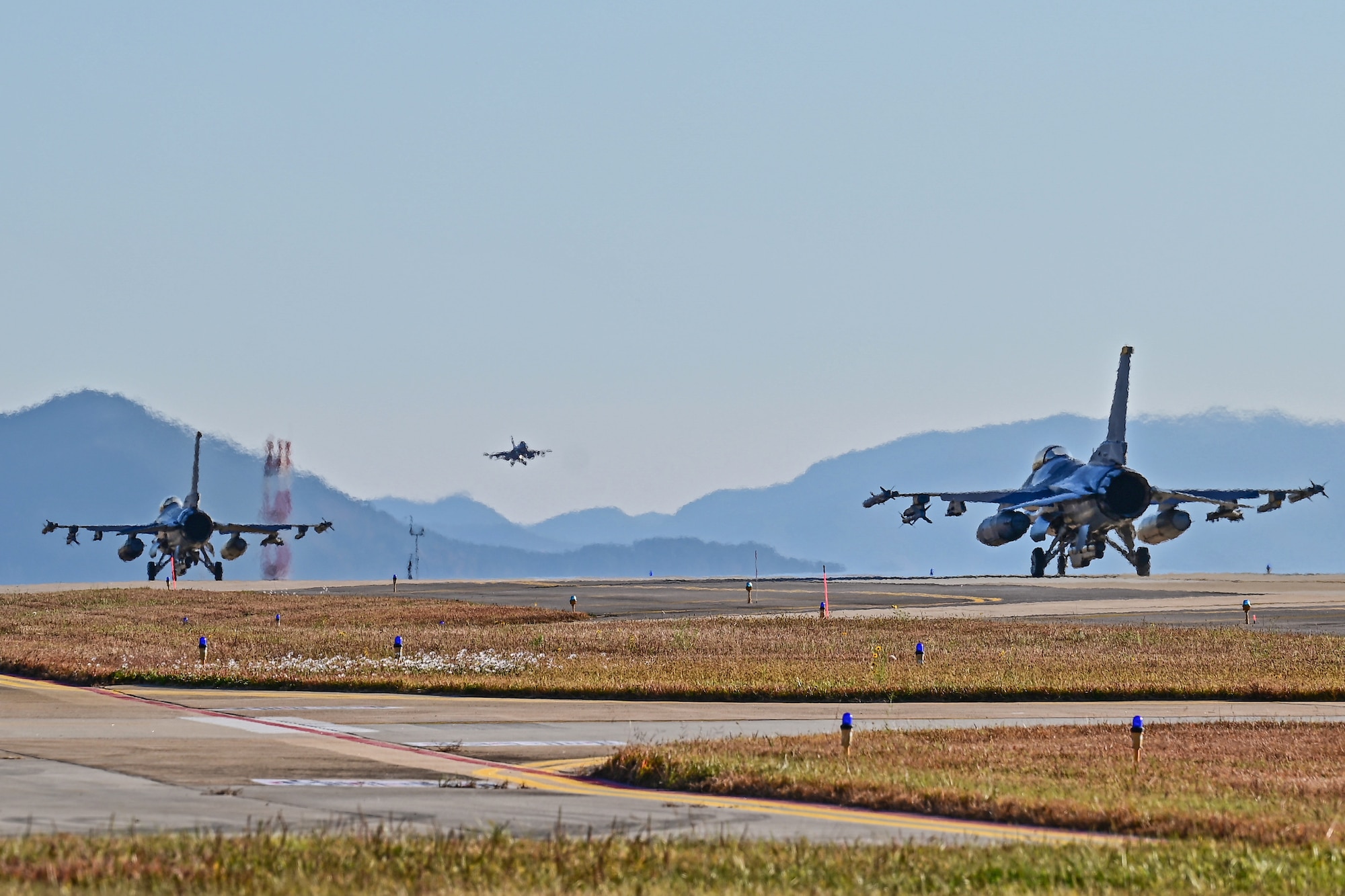 Two U.S. Air Force F-16 Fighting Falcons with the 80th Fighter Squadron taxi as a Republic of Korea Air Force F-16 Fighting Falcon passes by during the fiscal year 2023 combined flying training event at Kunsan Air Base, Republic of Korea, Nov. 2, 2022.