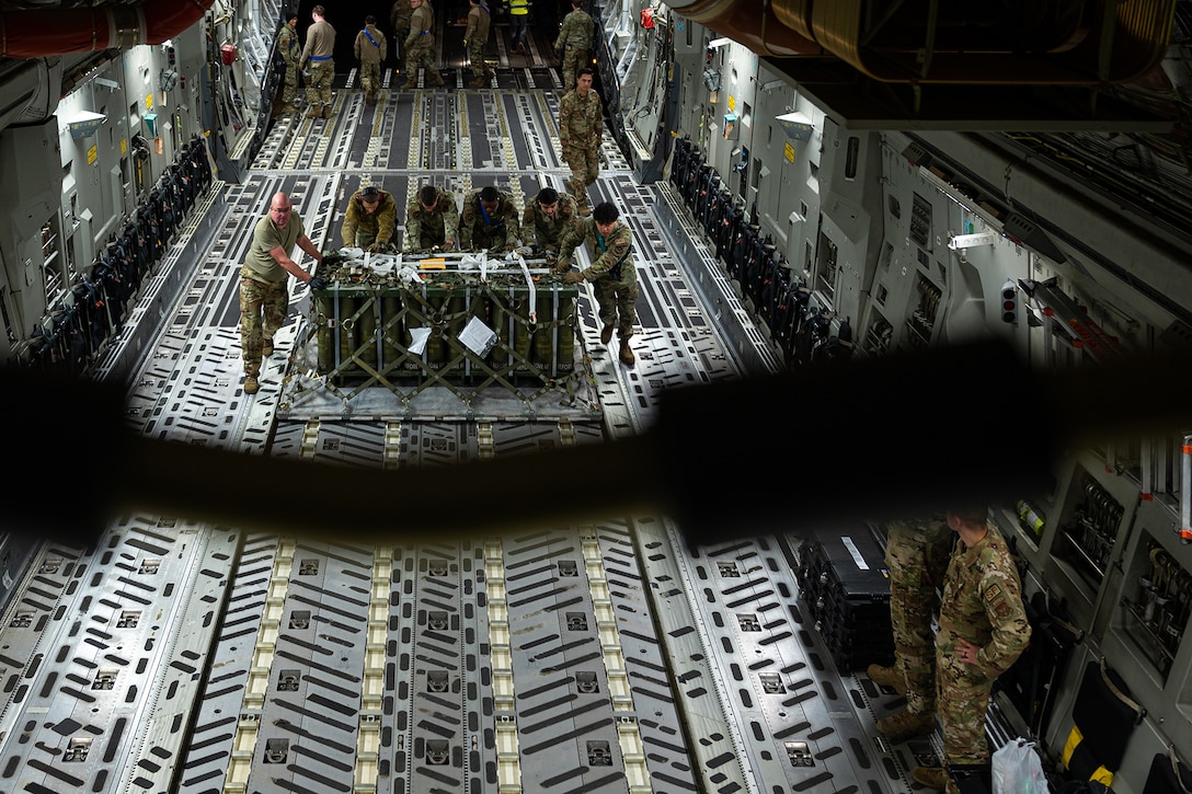 Airmen load cargo onto a C-17 Globemaster III.