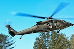 An Oregon Army National Guard HH-60M Black Hawk helicopter takes off from a landing zone during the 2022 Best Warrior Competition, March 19, 2022, at Camp Rilea near Warrenton, Ore.