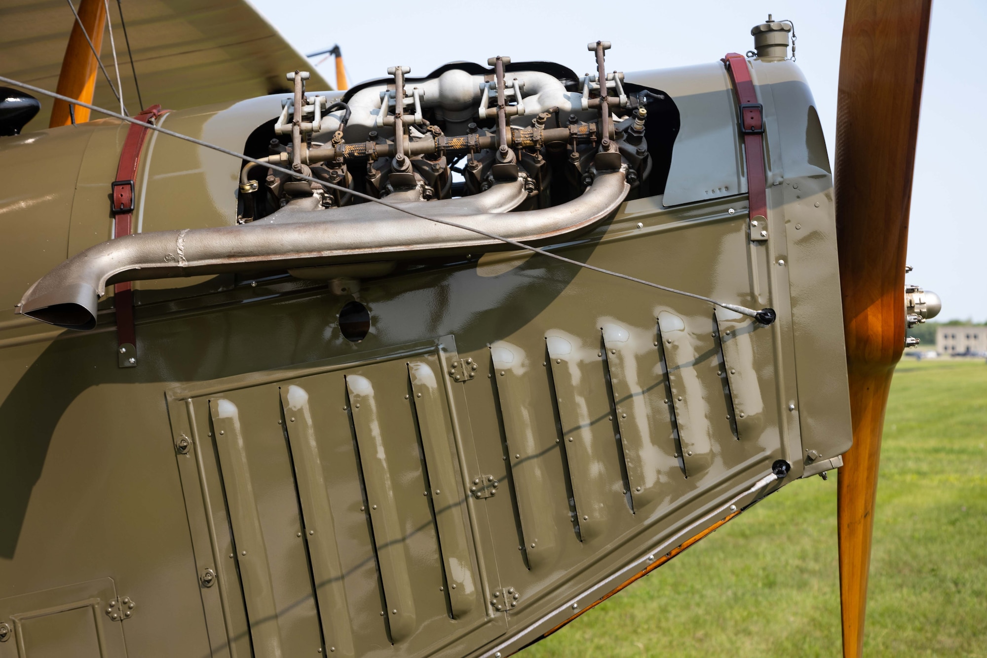 side view of the nose of the aircraft with the engine and propeller in focus.