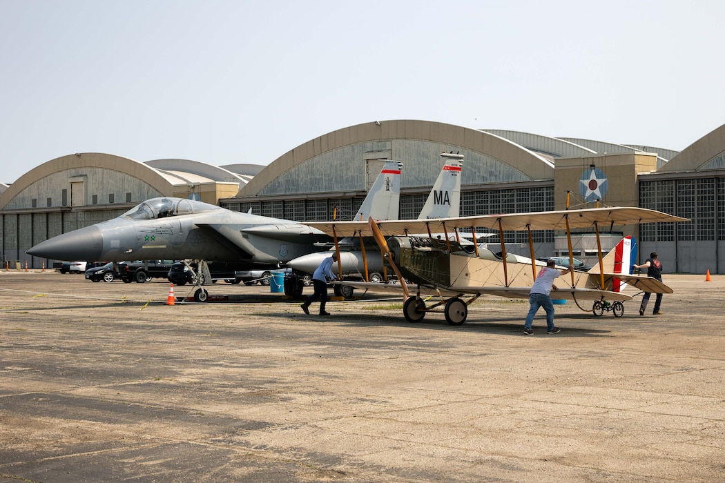 The Jenny sits outside the museum's restoration hangar with a F-15C behind it.