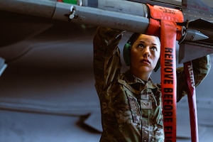 Staff Sgt. Quinn Ball, 56th Maintenance Group weapons load crew member, secures an AIM-9X Sidewinder to an F-35A Lightning II