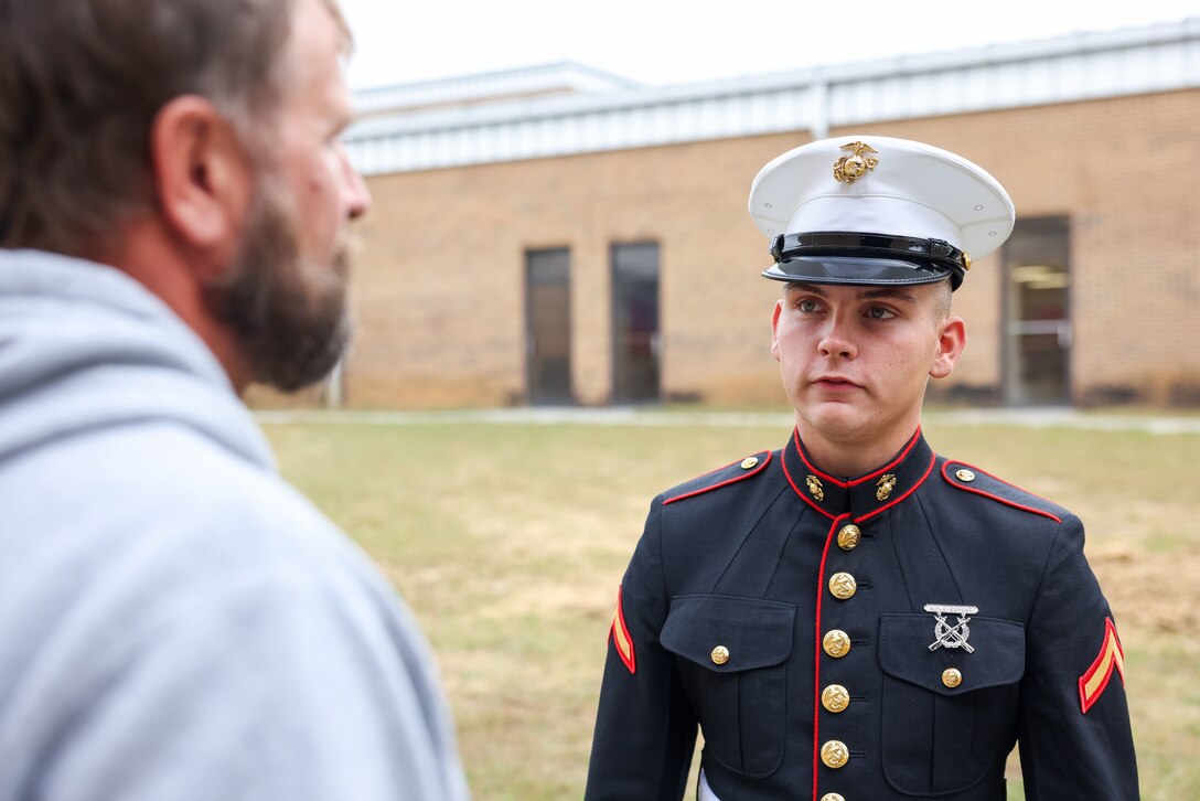 U.S. Marine Corps Pfc. Jarrod Eggleston, right, a Marine under the command recruiting program at Recruiting Substation Murfreesboro, Recruiting Station Nashville, pays a visit to Herbert Nugent, left, his former construction teacher at Coffee County Central High School, Manchester, Tennessee, Oct. 19, 2023. This program offers new Marines the opportunity to return to their recruiting station in support of recruiting efforts. (U.S. Marine Corps photo by Cpl. Bernadette Pacheco)