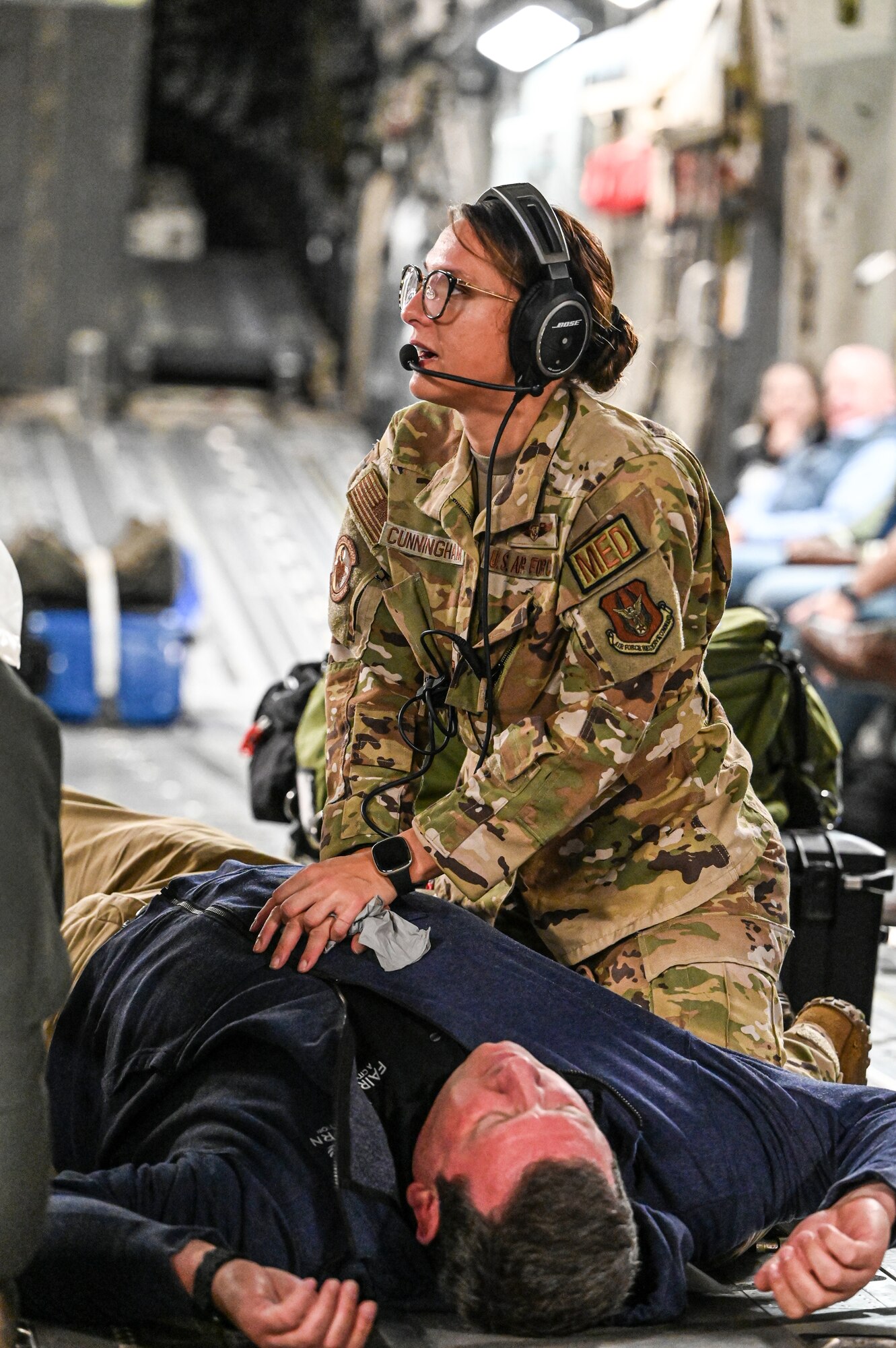 Robert Anderson, Fairborn City Manager, poses as a chocking patient and is treated by Capt. Alexandra Cunningham, 445th Aeromedical Evacuation Squadron flight nurse, during a training flight Oct. 18, 2023 to Joint Base San Antonio-Lackland, Texas. Anderson was one of 22 Dayton, Ohio civic leaders invited to participate in a civic leader tour in conjunction with the 433rd Airlift Wing at Joint Base San Antonio-Lackland, Texas, Oct. 18-19, 2023. (U.S. Air Force photo/Master Sgt. Patrick O’Reilly)