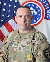 Army Recruiting Soldier in front of United States and USAREC flags