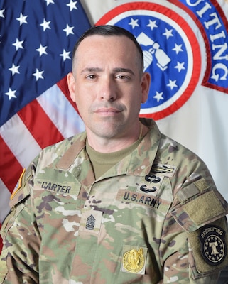 Army Recruiting Soldier in front of United States and USAREC flags