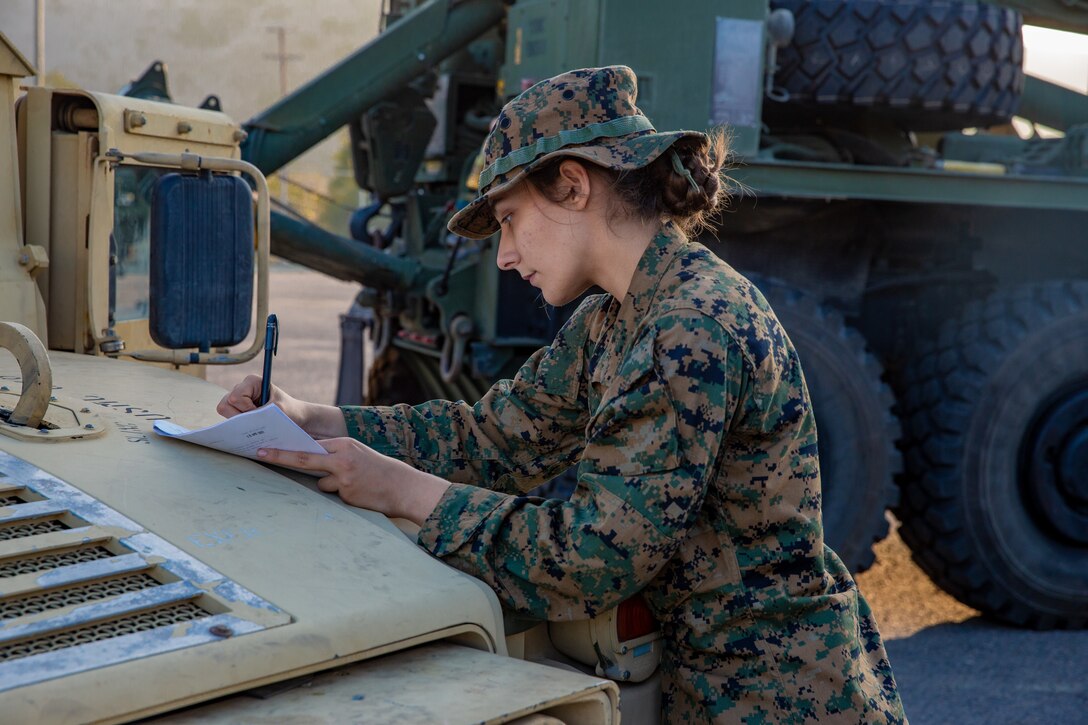 U.S. Marine Corps Lance Cpl. Qearia Braden, a transmissions system operator with Combat Logistics Battalion 5, Combat Logistics Regiment 1, 1st Marine Logistics Group, completes a vehicle checklist during Exercise Steel Knight 22 (SK-22) at Camp Pendleton, California, Dec. 5, 2021. SK-22 is a 1st Marine Division led annual training exercise which enables the Navy-Marine Corps team to operate in a realistic, combined-arms environment to enhance naval warfighting tactics, techniques and procedures. (U.S. Marine Corps photo by Lance Cpl. Mackenzie Binion)