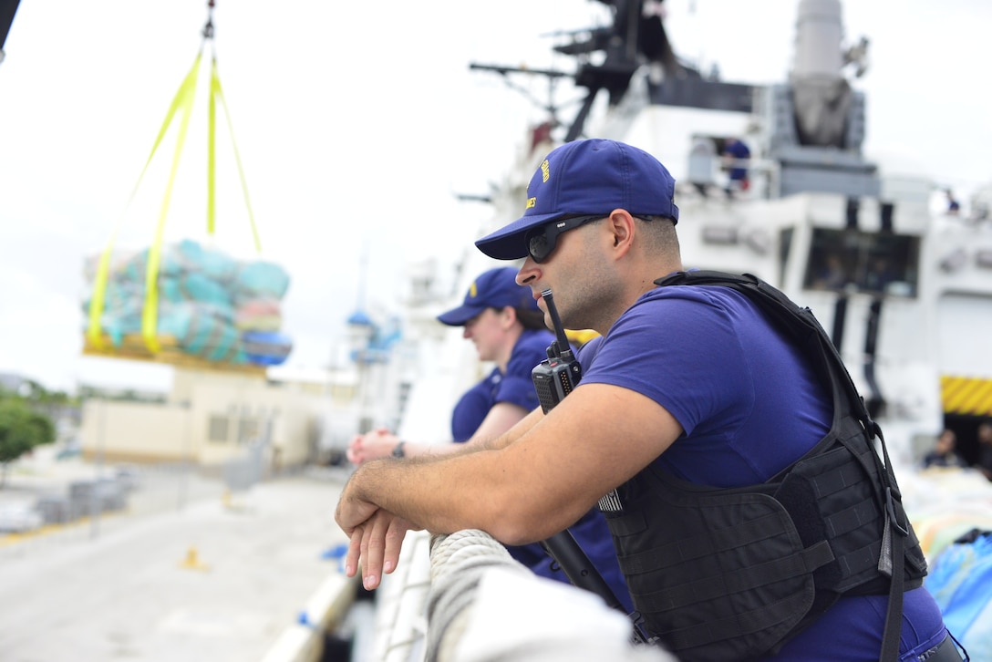 A crewmember of the Coast Guard Cutter James assists with the offload of more than $445 million in illegal drugs seized by Coast Guard and partner agencies in Port Everglades, Florida, Oct 26, 2023. The offload is a result of suspected drug smuggling interdictions in the Caribbean and Eastern Pacific Ocean. (U.S. Coast Guard photo by Chief Petty Officer Stephen Lehmann.)