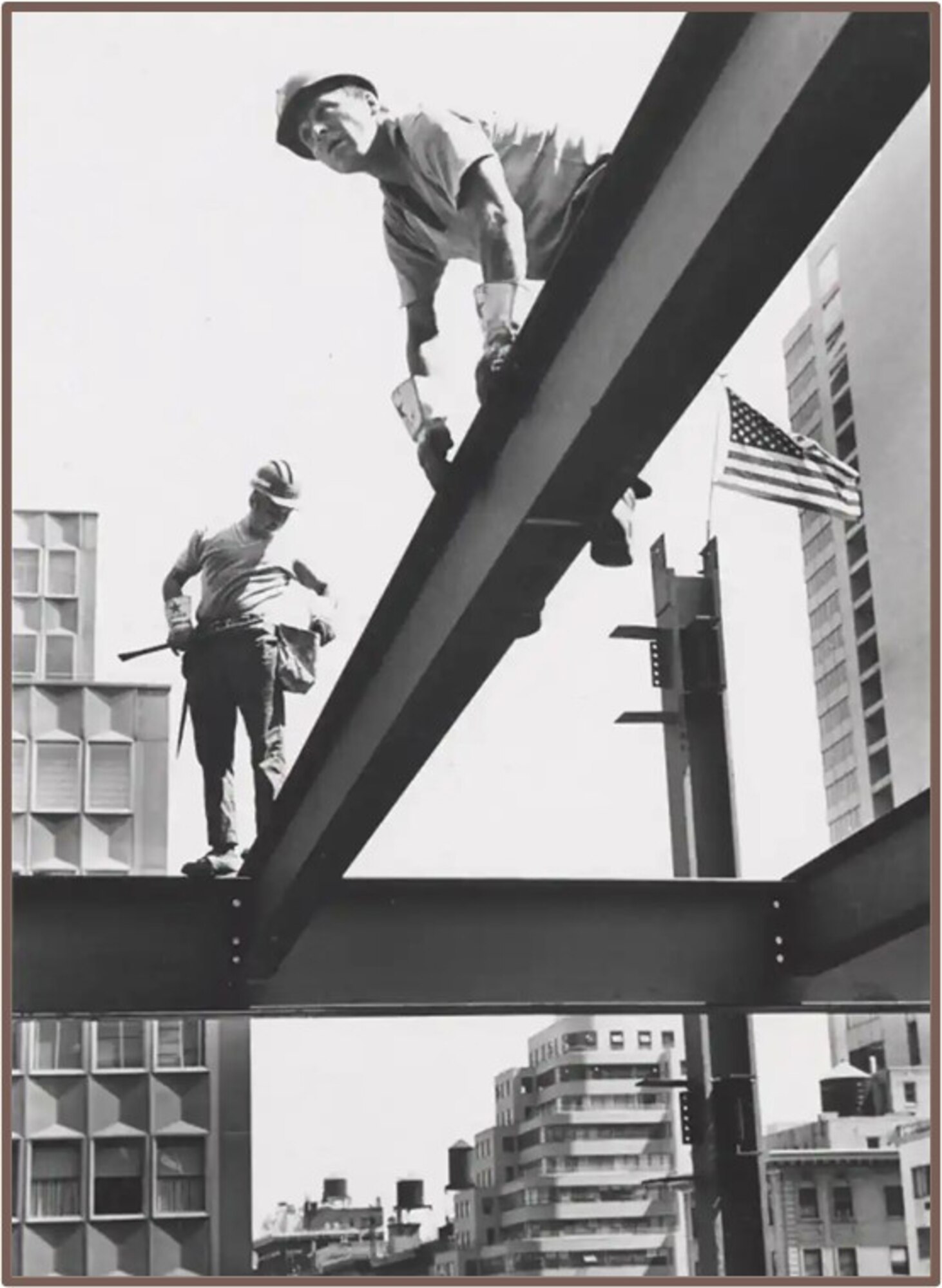 Black and white photo of five men working on a steel beam.