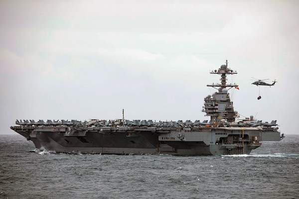 MH-60S Seahawk helicopter, assigned to “Tridents” of Helicopter Sea Combat Squadron 9, takes off from aircraft carrier USS Gerald R. Ford as it prepares to conduct vertical replenishment with Ticonderoga-class guided-missile cruiser USS Normandy, May 12, 2023, in Atlantic Ocean (U.S. Navy/Malachi Lakey)