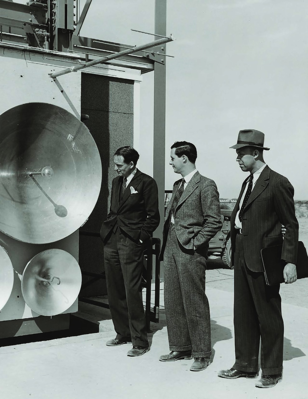 A scan, taken Oct. 26, 2023, of an archival photo, taken in 1946 near Sentinel, Arizona, shows men looking at an early antenna communication system developed by engineers of a predecessor lab of Naval Information Warfare Center (NIWC) Pacific, headquartered in San Diego.